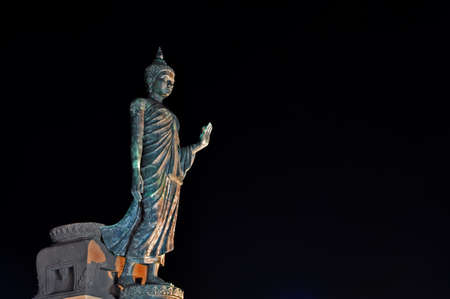 Walking image of Buddha posture at night in Phutthamonthon, The Thai center  of Buddhism located in Nakornpathom Thailandの写真素材