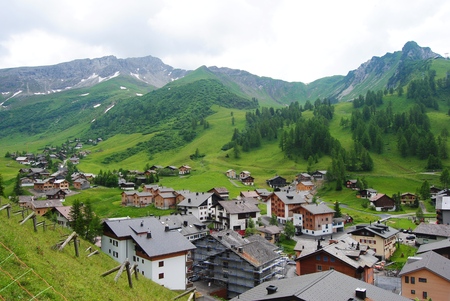 Malbun, Liechtenstein - July 9, 2013. The 1600m-high resort of Malbun feels truly like the edge of the world - in the best possible sense. View of the village with buildings and pine-clad mountains in the background.のeditorial素材