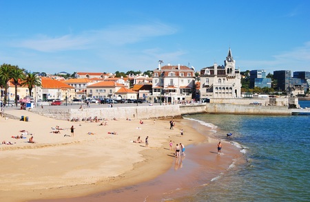 Cascais, Portugal - October 23, 2014. Praia da Ribeira beach in Cascais, with historic and commercial buildings in the distance and people.のeditorial素材
