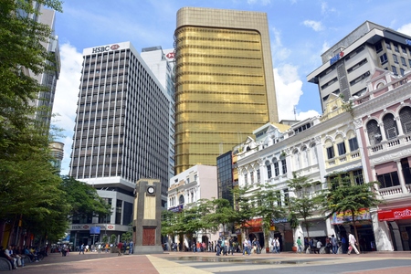 Kuala Lumpur, Malaysia - November 29, 2015. City square in downtown Kuala Lumpur, with clock tower, commercial and residential buildings and people.のeditorial素材