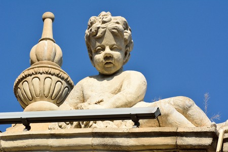 Baku, Azerbaijan - July 23, 2017.  Sculpture of angel boy on facade of architectural building in downtown Baku.のeditorial素材