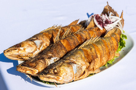 Plate with three pike-perch fish served in a fishing restaurant in Bibi-Heybat settlement of Baku,...