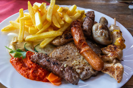 Mixed grill platter with grilled meat and sausages in Slovenia.