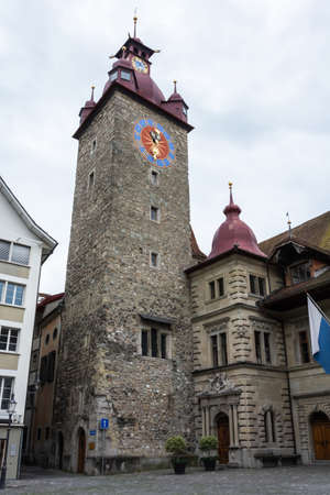 Lucerne, Switzerland - June 26, 2016. Tower of the Rathaus building on Kornmarkt square in Lucerne. The tower  was erected in the High Middle Ages later serving as a dungeon and finally housing the town-hall clock.のeditorial素材