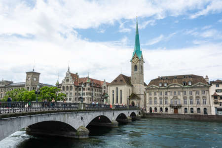 Zurich, Switzerland â June 25, 2016. View of Munsterbrucke bridge and Fraumunster church in Zurich, with surrounding historic buildings and people.のeditorial素材