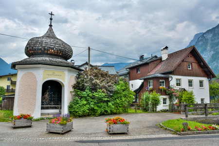 Hallstatt, Austria â July 9, 2016. Street view in Hallstatt with Kreuzwegkapelle I chappel and a residential building.のeditorial素材