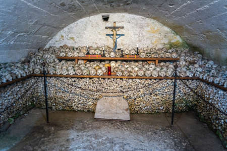 Hallstatt, Austria â July 9, 2016. Interior view of Beinhaus charnel house in St Michael chapel of Hallstatt, with rows of stacked skulls. A small chapel has been filled with over 1,200 skulls. Skull painting was carried out especially during the 19th cのeditorial素材