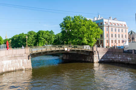 Saint Petersburg, Russia â June 15, 2017.  Malo-Konyushennyi Bridge across the Moyka River in Saint Petersburg, with historic buildings and people.のeditorial素材