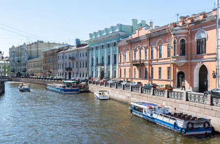 Saint Petersburg, Russia â June 15, 2017. View of Moyka River and embankment in Saint Petersburg, with historic buildings, commercial properties, boats, cars and people.のeditorial素材