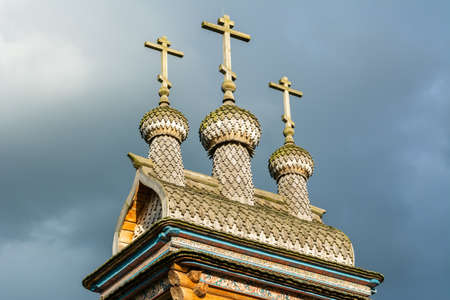 Moscow, Russia â July 6, 2017. Crosses and onion domes of wooden St. George Church at Kolomenskoe museum-reserve in Moscow. The church was built by Yorga riverside in the 17th century and moved to Kolomenskoe during 2008-2011.のeditorial素材