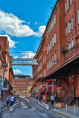 Moscow, Russia â June 20, 2017. Street view in Krasny Oktyabr (Red October) redeveloped area on Bersenevskaya Embankment in Moscow. View with historic red-brick buildings, commercial properties and peopleのeditorial素材