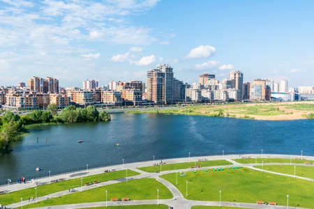 Kazan, Russia â June 27, 2017. View of Kazanka River embankment in Novo-Savinovskiy district of Kazan. View with residential buildings, commercial properties and cars.のeditorial素材
