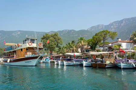 Akyaka, Mugla, Turkey - July 30, 2016. Boats on Azmak stream in Akyaka village in Mugla province of Turkey, with Sakar mountains in the background.のeditorial素材