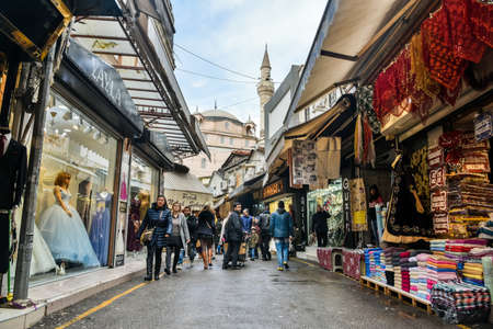 Izmir, Turkey - January 26, 2019. Street view in Kemeralti market in Izmir, with shops and people, toward Sadirvan mosque.のeditorial素材