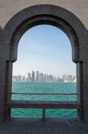 Doha, Qatar - November 9, 2016. Doha skyline viewed through the arches of the Museum of Islamic Art in Doha.のeditorial素材