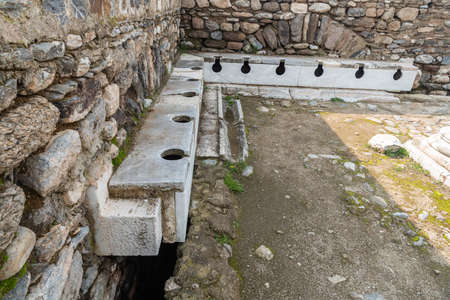 Sitting place of the Latrina (public toilet) in Tralleis (Tralles) ancient city in Aydin, Turkey.の写真素材