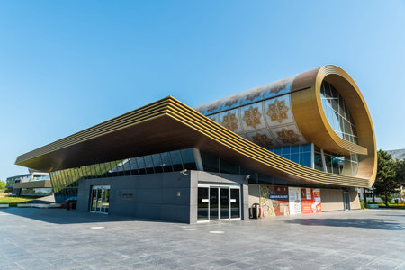 Baku, Azerbaijan â August 2, 2020. Carpet Museum, designed as partly unfurled rug, on the seaside boulevard in Baku. Designed by Austrian architect Franz Janz, the building was completed in 2014. Exterior view in summer.のeditorial素材