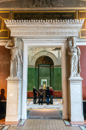 Berlin, Germany â January 29, 2018. Interior view of Neues Museum in Berlin, toward the bust of Egyptian queen Nefertiti, with people gathered around the sculpture. Her bust was created around 1340 BC by the court sculptor Thutmose.のeditorial素材