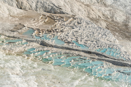 Travertine terrace formations in Pamukkale, Turkey. The area is famous for a carbonate mineral travertines left by the flowing of thermal spring water.の写真素材
