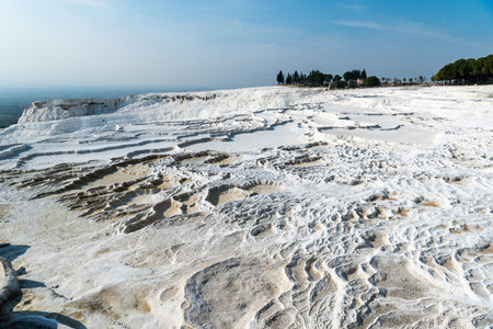 Travertine terrace formations in Pamukkale, Turkey. The area is famous for a carbonate mineral travertines left by the flowing of thermal spring water.の写真素材