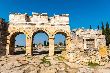 Pamukkale, Denizli, Turkey â November 18, 2020. Frontinus Gate at Hierapolis ancient site in Denizli province of Turkey. This is the monumental entrance to the Roman city and leads onto the large plateia. The well preserved structure with three openingsのeditorial素材