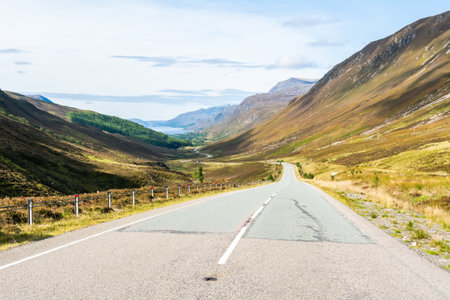 A832 road running through Glen Docherty in Scotland. View toward Loch Maree lake.の写真素材