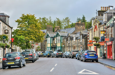 Dufftown, Scotland, United Kingdom â September 16, 2017. Church Street in Dufftown, Scotland. View with cars, commercial properties and historic buildings on a cloudy day.のeditorial素材
