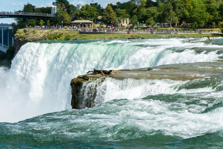 Niagara Falls, New York, United States of America â September 12, 2016. The American Falls, the second-largest of the three waterfalls that together are known as Niagara Falls on the Niagara River along the CanadaâU.S. border. View with people at Lunaのeditorial素材