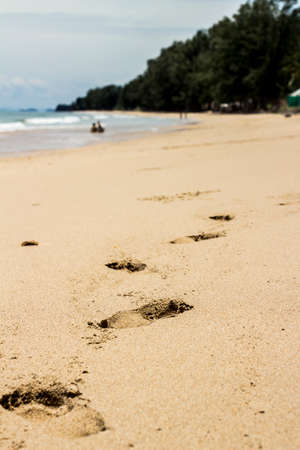a foot print on the sand at a beach in lanta island thailandの写真素材