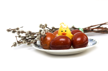 Happy Easter. Easter eggs on a plate with a yellow chicken. Photo.の写真素材