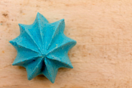 Blue, sweet, crispy meringue on a wooden background.の写真素材