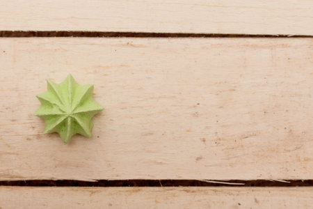 Green, sweet, crispy meringue on a wooden background. Photo.の写真素材