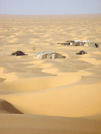 Small collection of tents in the middle of the Sahara desert in Tunesiaの写真素材