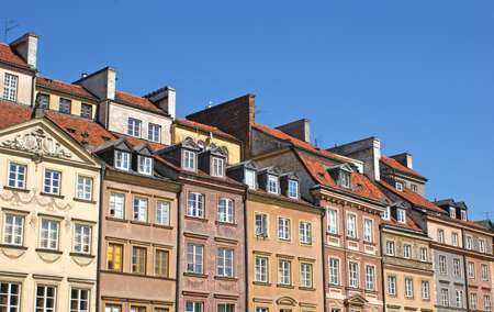 The front of houses on a sunny day in the center of the old town of Warsawの写真素材