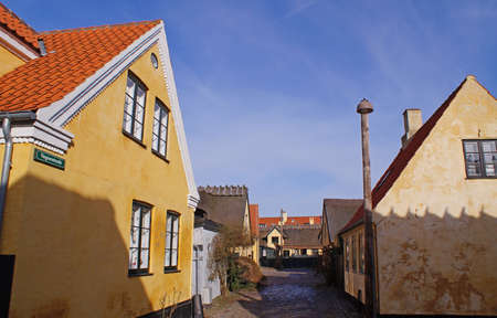 Narrow street with traditional yellow houses in the center og Dragoerの写真素材