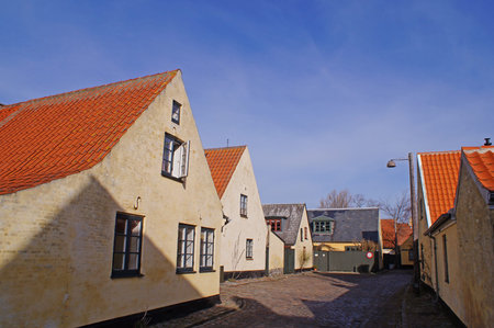 A narrow street with old yellow houses in the center of Dragoerの写真素材