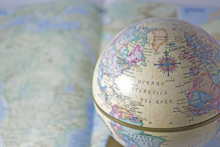 globe on an open atlas to maximize the search resultの写真素材