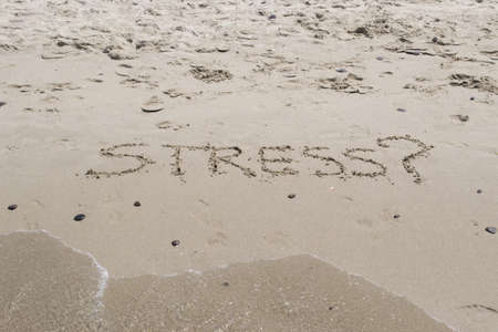 "stress?" writing on the foreshoreの写真素材