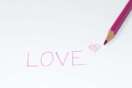love writing with heart on a white sheet with a fuchsia pencilの写真素材