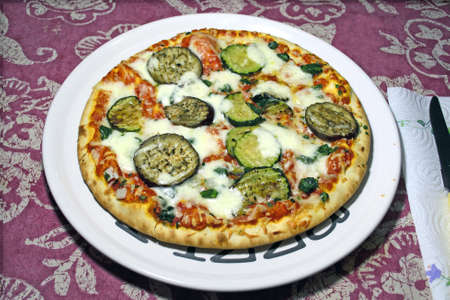 colorful pizza with eggplant on a pizza plateの写真素材