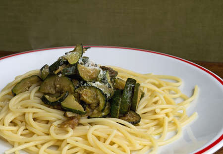 spaghetti and zucchini on a wooden tableの写真素材