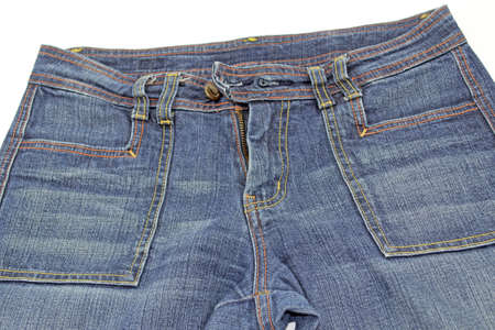 close up of a front view of a pair of blue jeans with yellow and orange seamsの写真素材