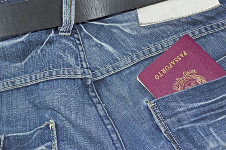 italian passport in the blue jeans pocketの写真素材