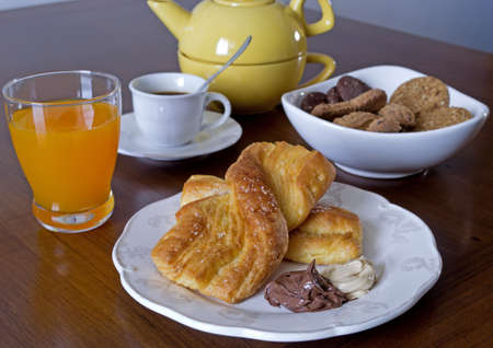 breakfast set with snack, fruit juice, cookies, coffee and teaの写真素材