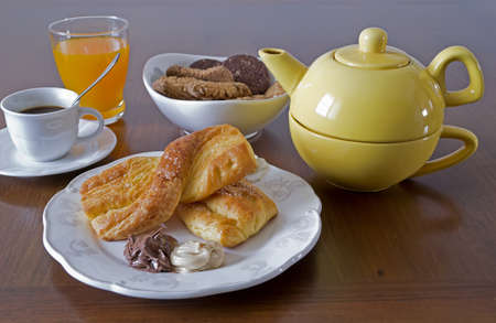 breakfast set with snack, fruit juice, cookies, coffee and teaの写真素材