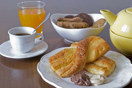 breakfast set with snack, fruit juice, cookies, coffee and teaの写真素材