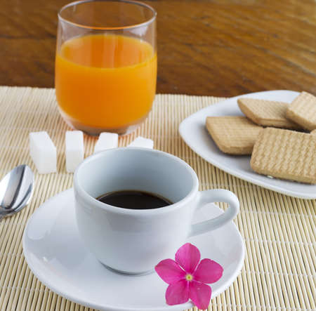 cup of coffee and glass of juice on a place matの写真素材