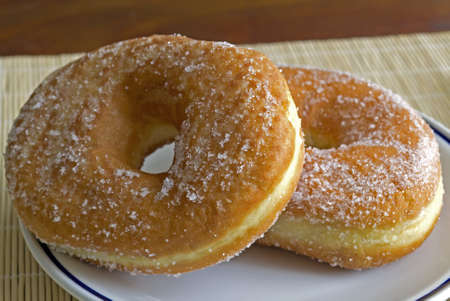 donuts with sugar on a ceramic plateの写真素材