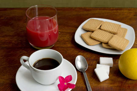 espresso, juice, cookies and grapefruit on a wooden tableの写真素材