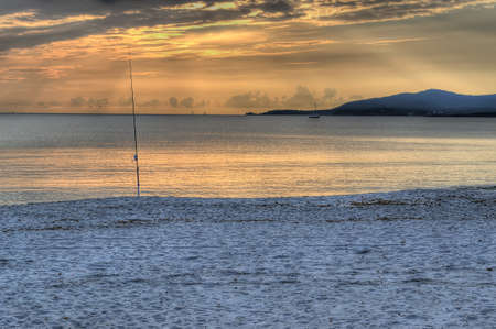 fishing rod at sunset の写真素材